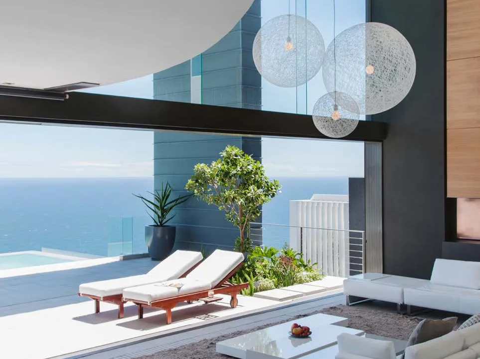 A terrace with loungers over a private pool